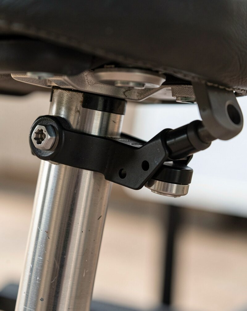 Close-up of a tag-along hitch coupling under a seat post